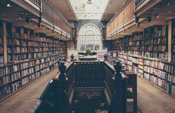 law library with stair case and decorative moon roof